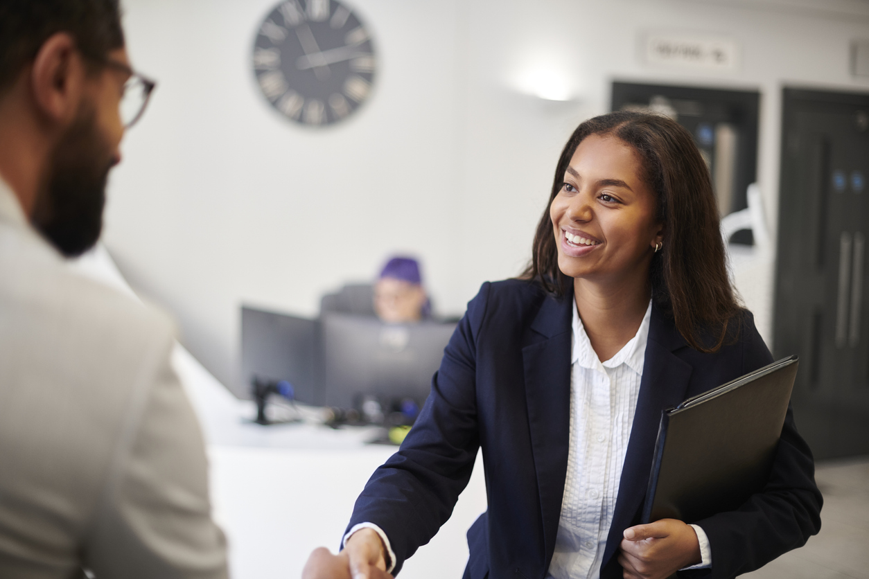 A Court Professional in a Suit Shaking Hands With a Colleague..jpg