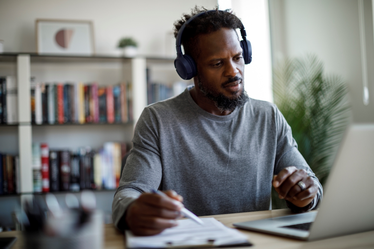 Student working at a desk wearing headphones.